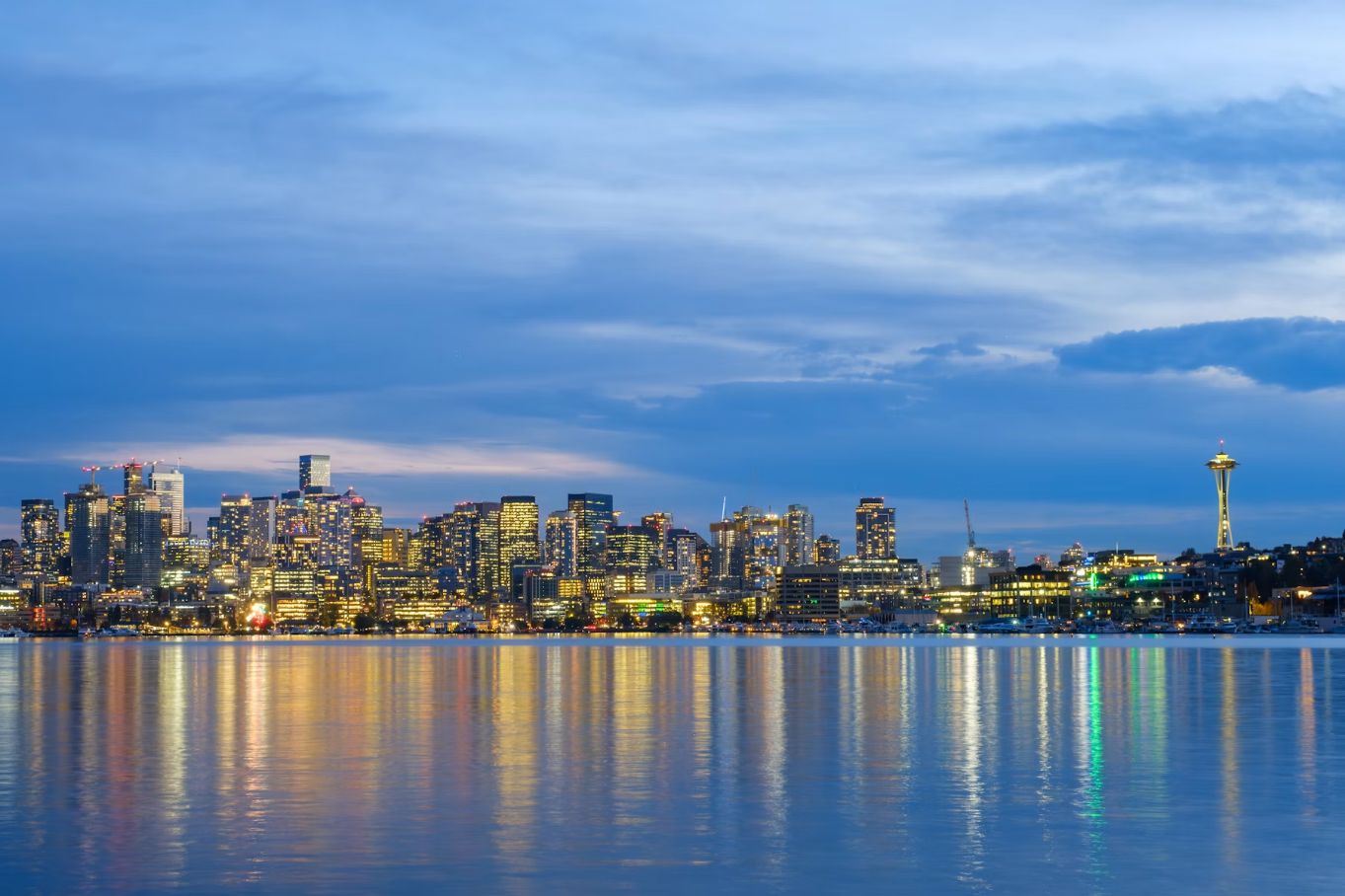 Seattle skyline at dusk with the Space Needle and waterfront reflections